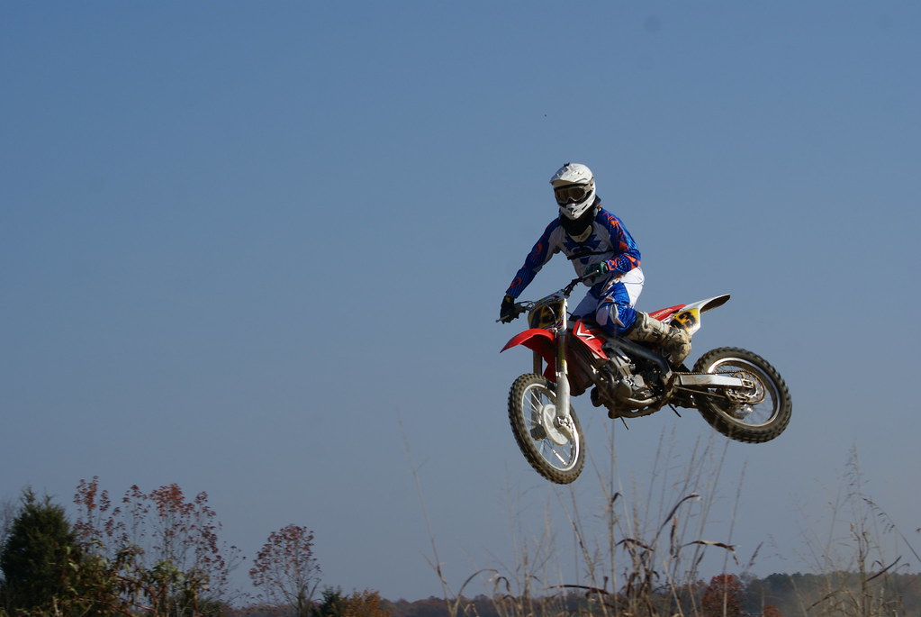 Rider jumping against a clear blue sky