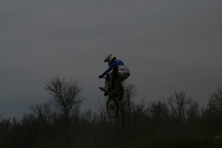 Silhouette of a rider jumping at dusk