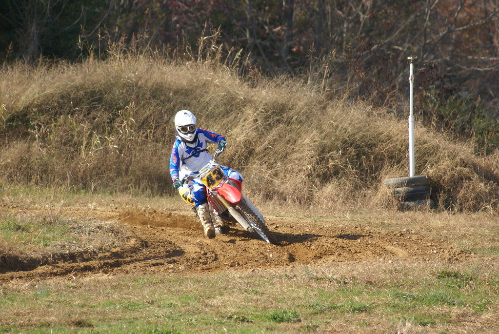 Honda rider cornering on the grass track