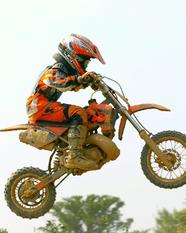 Kid catching air on a pit bike